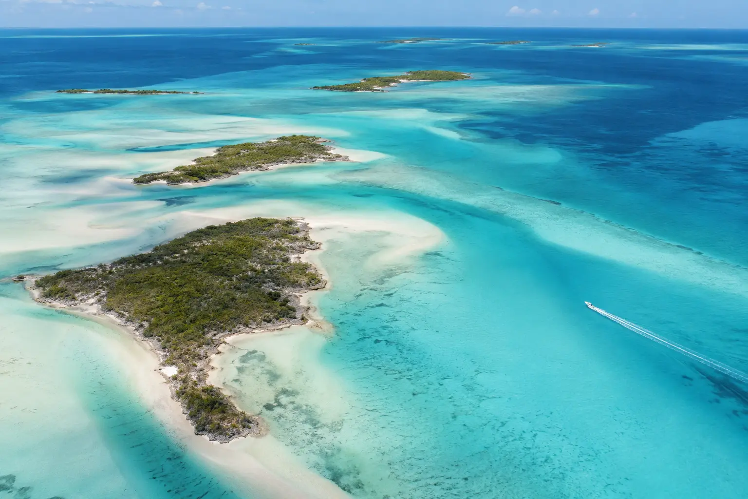 Open turquoise water and small green cays in Great Exuma