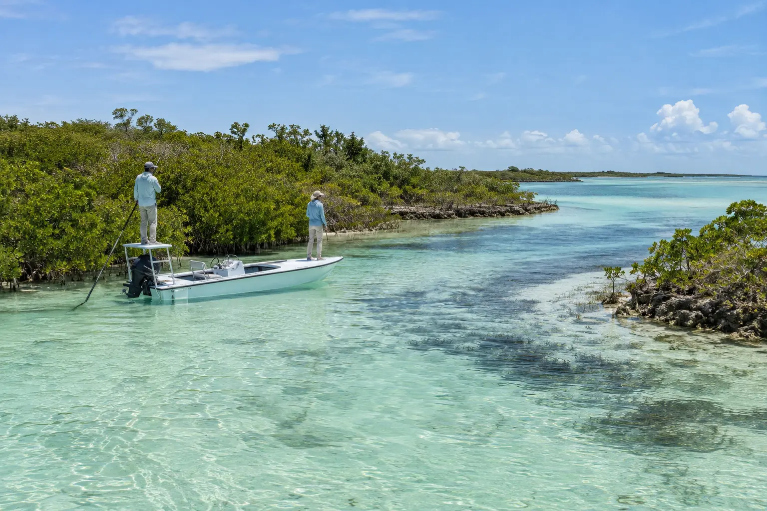 Flats skiff moving quietly along a mangrove creek